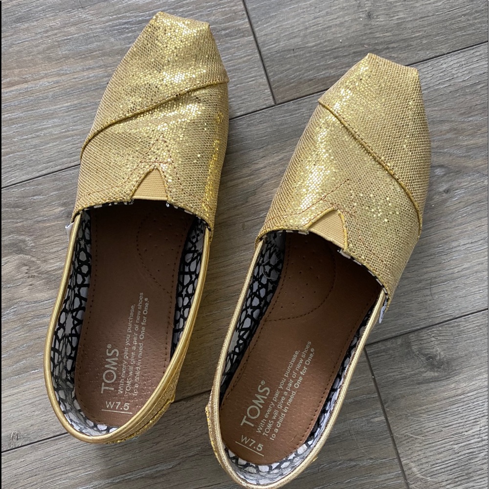 Gold glitter Tom's slip ons